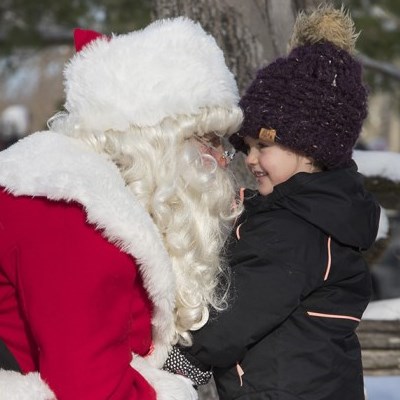 Santa Claus talking with a young visitor at Christrmas at Ken Reid