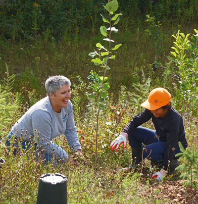 A woman and child planting a tree